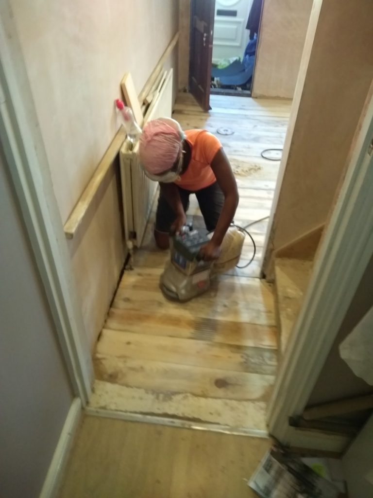 Sanding The Floorboard To An Even Finish Ready For Staining