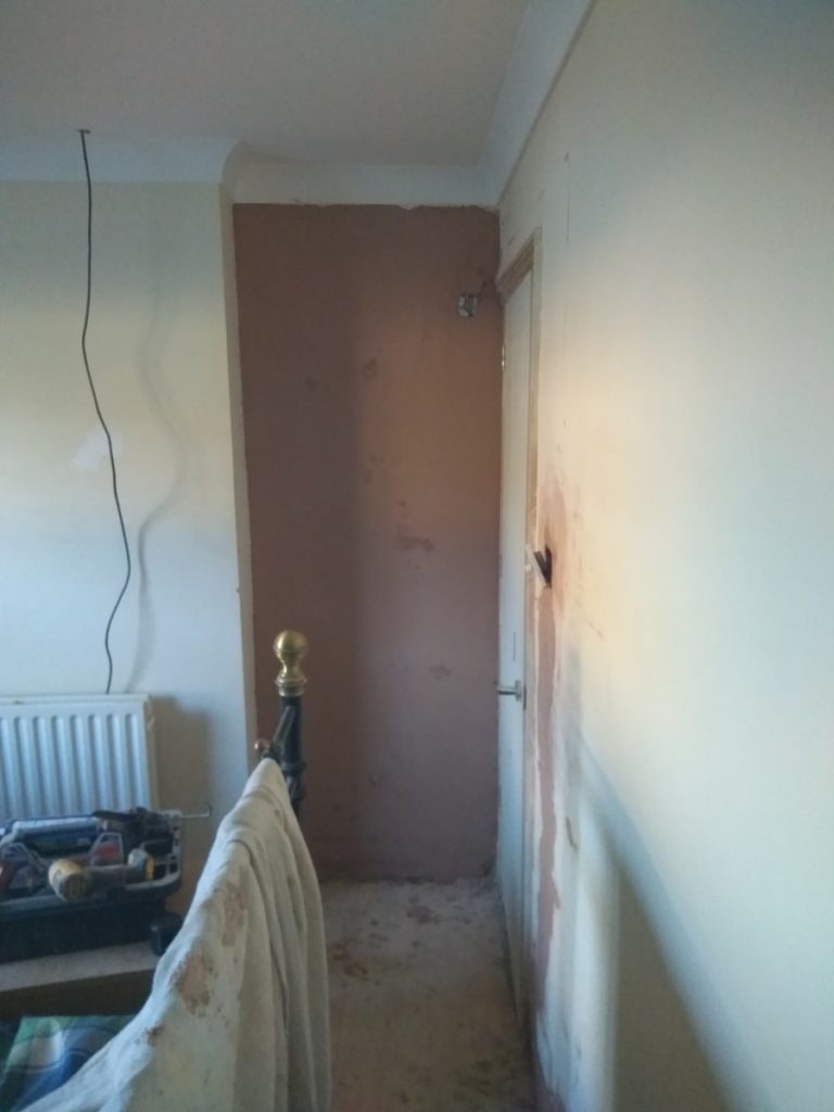 plastering the front bedroom and repairing the lower walls