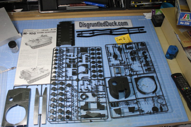 All The Parts Of The Italleri M-108 105MM Howitzer Laid Out On The Workbench