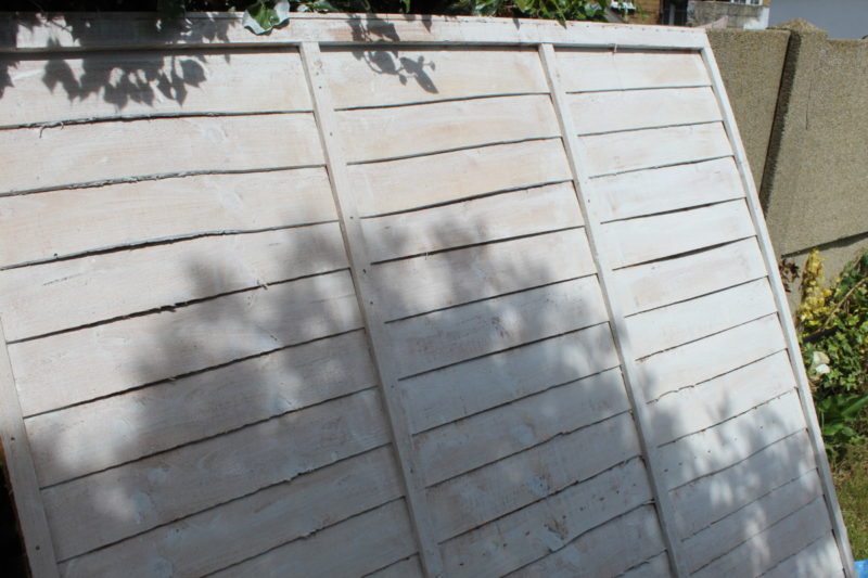 The Fence Panel Painted With And Undercoat Of White Paint