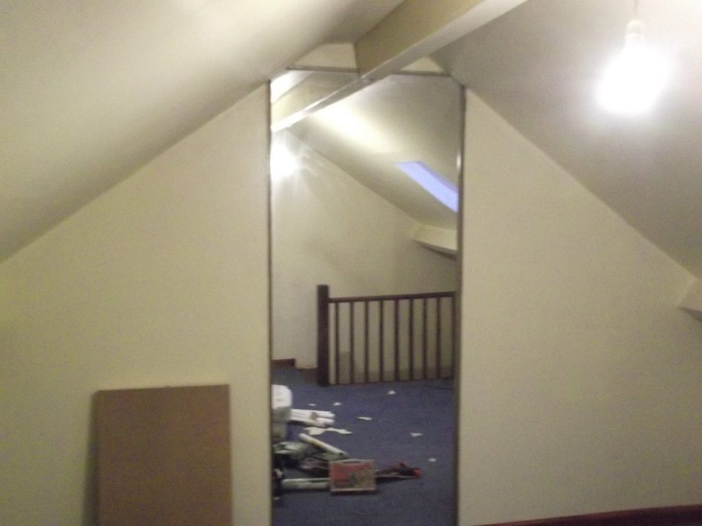 Back Wall Of Loft Room With Floor To Ceiling Mirror