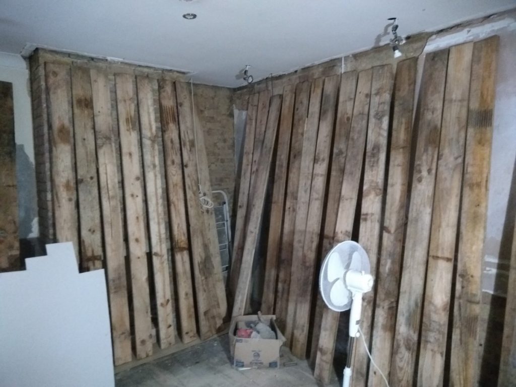 Floorboards Upright Against The Wall To Dry Out