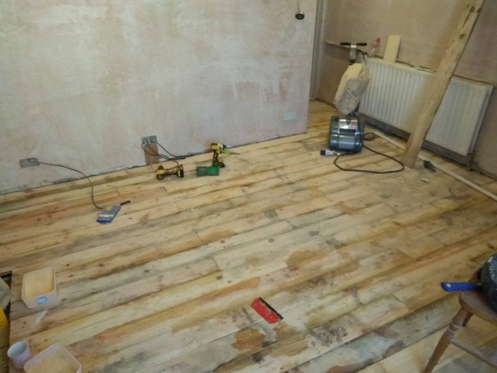 Gap In Floorboards Filling With Resin And Sawdust