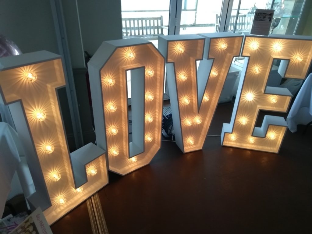 Love Sign Made Of Wood With Light Bulbs.