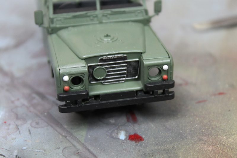 Painting In The Details On The Front Of The Land Rover Scale Model